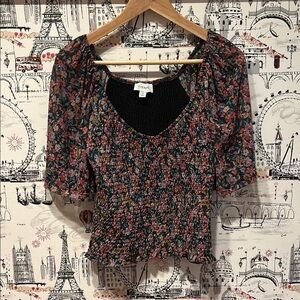 Evereve - Black Floral Smocked top. Mesh sleeves and scoop neck.
